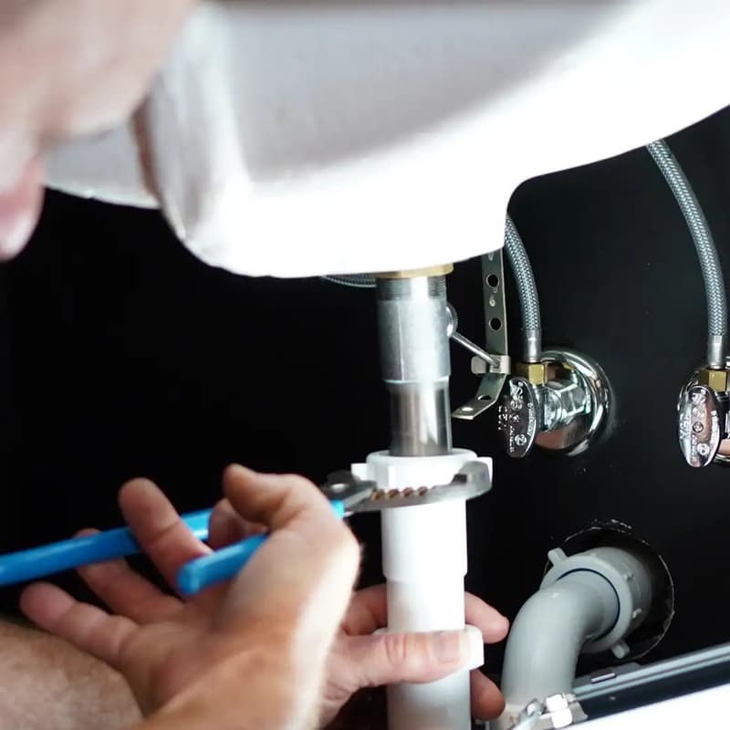Close view of hands tightening sink drain pipe